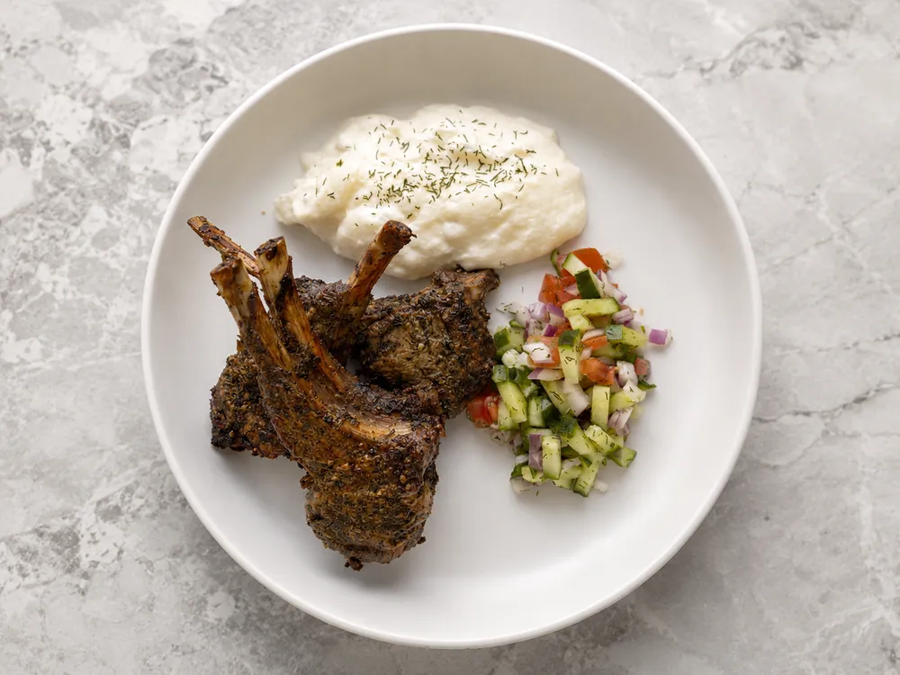 Herb-crusted lamb chops with tzatziki and Mediterranean salad